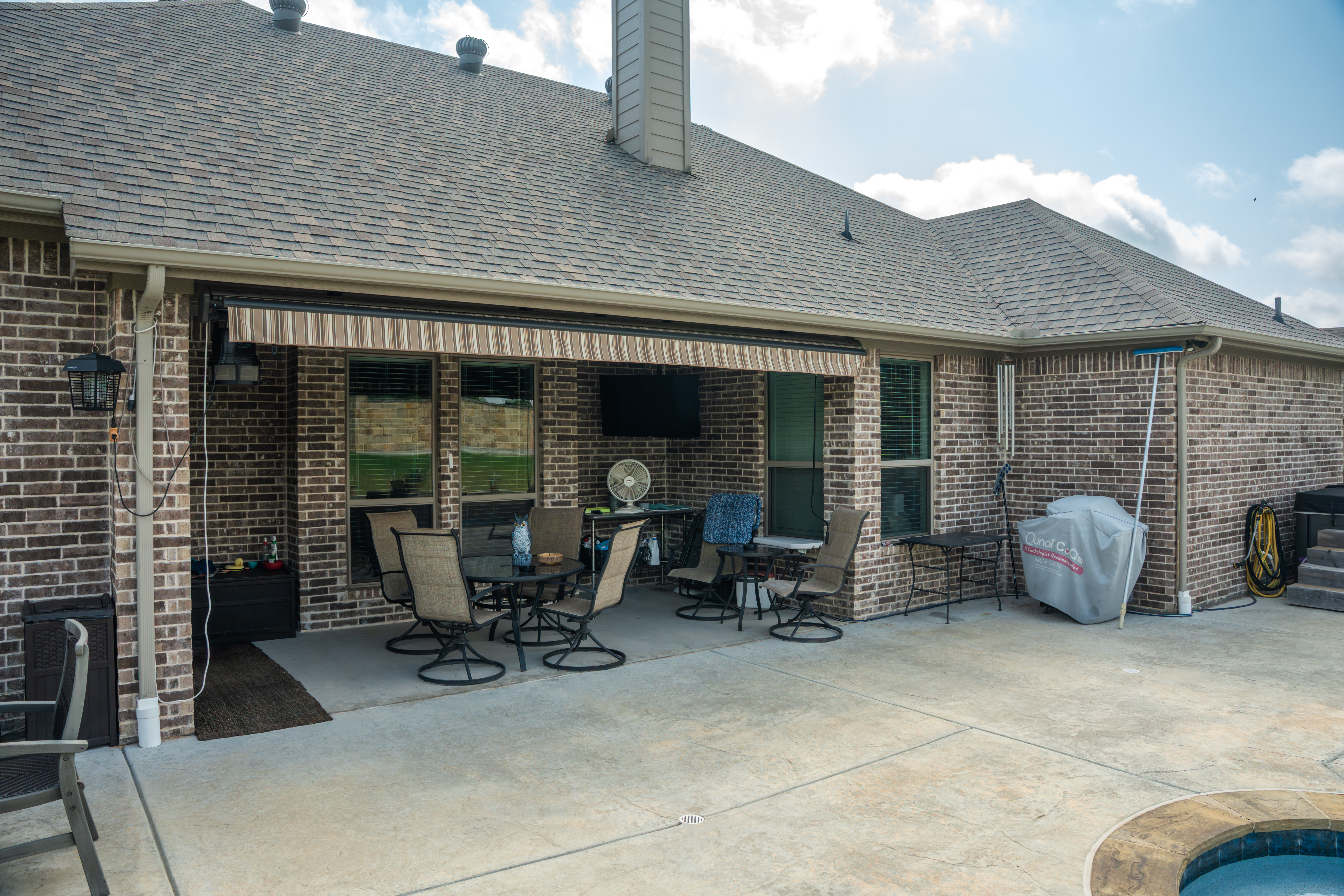 Awning Residential Patio Pool Brick House Retracted View